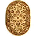 Hand-tufted Heritage Kerman Ivory/ Brown Wool Oval Rug (7'6 x 9'6)